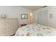 Bedroom with a white dresser, shell-themed bedding, and closet access at 7921 4Th W Ave, Bradenton, FL 34209