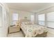 Bright bedroom with white walls, shell-themed bedding, and two windows at 7921 4Th W Ave, Bradenton, FL 34209