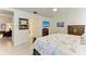 Bedroom featuring tile floors, flatscreen TV, and dresser with drawers at 7921 4Th W Ave, Bradenton, FL 34209