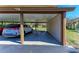 Carport providing covered parking and protection from the elements with neutral paint at 7921 4Th W Ave, Bradenton, FL 34209