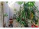 Enclosed courtyard garden with lush tropical plants and a decorative fountain at 7921 4Th W Ave, Bradenton, FL 34209