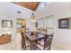 Cozy dining area with wood table set beneath vaulted ceilings and decorative chandelier lighting at 7921 4Th W Ave, Bradenton, FL 34209