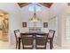 Elegant dining room featuring a modern table set, vaulted wood ceilings, and a unique chandelier at 7921 4Th W Ave, Bradenton, FL 34209