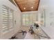 Bright foyer with a glass table, modern rug, and natural light streaming through shuttered windows at 7921 4Th W Ave, Bradenton, FL 34209