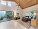 Open-concept living room with vaulted ceilings, a courtyard view, and tile floors at 7921 4Th W Ave, Bradenton, FL 34209