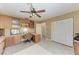 Home office with custom wood cabinets, built in shelving, and a ceiling fan at 7921 4Th W Ave, Bradenton, FL 34209