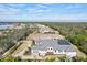 Aerial view showcasing home with screened-in pool and beautiful landscaping at 8487 Lindrick Ln, Bradenton, FL 34202