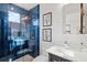 Modern bathroom featuring blue tile in shower, contemporary fixtures, and ample counter space at 8487 Lindrick Ln, Bradenton, FL 34202