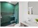 Stylish bathroom featuring sleek green tiling in the shower, complemented by modern fixtures and a vanity at 8487 Lindrick Ln, Bradenton, FL 34202