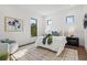 Bright bedroom with dual windows, dark wood floors, a statement artwork piece, and contemporary furnishings at 8487 Lindrick Ln, Bradenton, FL 34202