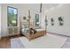 Bright bedroom with a four-poster bed, wood floors, and natural light streaming through the windows at 8487 Lindrick Ln, Bradenton, FL 34202