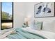 Well-lit bedroom with a window view, accented by a decorative lamp and soft blue accents at 8487 Lindrick Ln, Bradenton, FL 34202