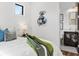 Bright bedroom with an open view to a modern bathroom, featuring a metal flower art piece and a side window at 8487 Lindrick Ln, Bradenton, FL 34202