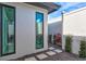 Modern courtyard with minimalist landscaping, a gravel bed, stepping stones, and narrow casement windows at 8487 Lindrick Ln, Bradenton, FL 34202