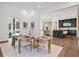 Bright dining room features a marble table, modern lighting, and access to the kitchen at 8487 Lindrick Ln, Bradenton, FL 34202