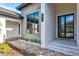 Elegant front entrance with a modern door and manicured landscaping at 8487 Lindrick Ln, Bradenton, FL 34202