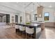 Bright, modern kitchen with island seating, stainless appliances, and views into the dining room at 8487 Lindrick Ln, Bradenton, FL 34202