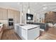 Modern kitchen features stainless steel appliances, a large island, and a view of the inviting living room fireplace at 8487 Lindrick Ln, Bradenton, FL 34202