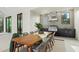 Inviting outdoor dining area with a modern kitchen, grill, and sleek black cabinets at 8487 Lindrick Ln, Bradenton, FL 34202