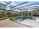 Expansive screened-in pool with pristine water features and seamless indoor/outdoor transition at 8487 Lindrick Ln, Bradenton, FL 34202