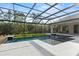 Stunning screened-in pool area with a lush wooded backdrop at 8487 Lindrick Ln, Bradenton, FL 34202