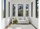 Cozy sitting area in the primary bedroom, featuring plush seating and natural light at 8487 Lindrick Ln, Bradenton, FL 34202