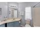 Bright bathroom featuring a vanity with a mirror and a shower/tub combo with a clean, neutral palette at 8536 Countess Avenue Cir, Palmetto, FL 34221