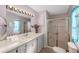 Well-lit bathroom with a vanity and a glass-enclosed shower for a clean and functional space at 8536 Countess Avenue Cir, Palmetto, FL 34221