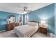 Charming bedroom featuring blue walls with matching dressers and bright windows at 8536 Countess Avenue Cir, Palmetto, FL 34221