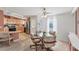 Bright dining area with kitchen view featuring a glass table and chair set with nearby kitchen entrance at 8536 Countess Avenue Cir, Palmetto, FL 34221