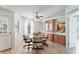 Bright dining area featuring a glass table, chair set, and built-in pink cabinetry with mirrored accents at 8536 Countess Avenue Cir, Palmetto, FL 34221