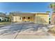 Inviting yellow home with a carport and concrete driveway, providing ample parking space at 8536 Countess Avenue Cir, Palmetto, FL 34221