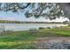 Bench at the edge of a grassy park overlooking a lake lined with homes at 8536 Countess Avenue Cir, Palmetto, FL 34221