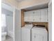 Convenient laundry area featuring a washer, dryer, and overhead cabinets located adjacent to the bathroom at 8536 Countess Avenue Cir, Palmetto, FL 34221