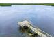 Aerial view of a wooden fishing pier extending into the calm waters of the bay at 866 Audubon Dr, Bradenton, FL 34209