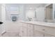 Bright bathroom with marble countertop, double sinks, and white beadboard paneling at 866 Audubon Dr, Bradenton, FL 34209