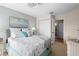 Bright bedroom with large bed, coastal decor, and a double door closet at 866 Audubon Dr, Bradenton, FL 34209