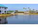 Exterior view of blue-roofed condos, complemented by palm trees and water views, creating a tranquil setting at 866 Audubon Dr, Bradenton, FL 34209