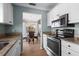 Modern kitchen with stainless steel appliances and granite countertops, open to the dining area at 866 Audubon Dr, Bradenton, FL 34209