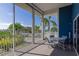 Screened lanai with a table and chairs overlooking lush landscaping at 866 Audubon Dr, Bradenton, FL 34209