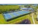 Aerial view of the tennis courts within a well-maintained community, surrounded by lush greenery at 866 Audubon Dr, Bradenton, FL 34209