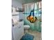 Well-lit bathroom with white vanity and creative goldfish-themed shower curtain at 9400 Little Gasparilla Is # F6, Placida, FL 33946