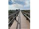 Scenic beach boardwalk leading to a gazebo, with a clear blue sky and white sand at 9400 Little Gasparilla Is # F6, Placida, FL 33946