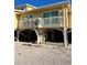 Coastal home exterior elevated on stilts, showcasing beachfront living with a balcony at 9400 Little Gasparilla Is # F6, Placida, FL 33946