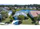 Aerial shot of home on a large lot with pond view and mature landscaping in established community at 9590 Knightsbridge Cir, Sarasota, FL 34238