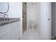 Clean bathroom with a shower, modern fixtures, and granite countertops at 9590 Knightsbridge Cir, Sarasota, FL 34238