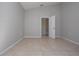 Neutral bedroom with tile floors and an open door at 9590 Knightsbridge Cir, Sarasota, FL 34238