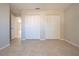 Bedroom featuring neutral decor, tile floors and a closet at 9590 Knightsbridge Cir, Sarasota, FL 34238