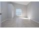 Neutral bedroom featuring tile floors, a window and closet at 9590 Knightsbridge Cir, Sarasota, FL 34238