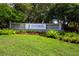 Community entrance sign with colorful flowers and lush green landscaping at 9590 Knightsbridge Cir, Sarasota, FL 34238